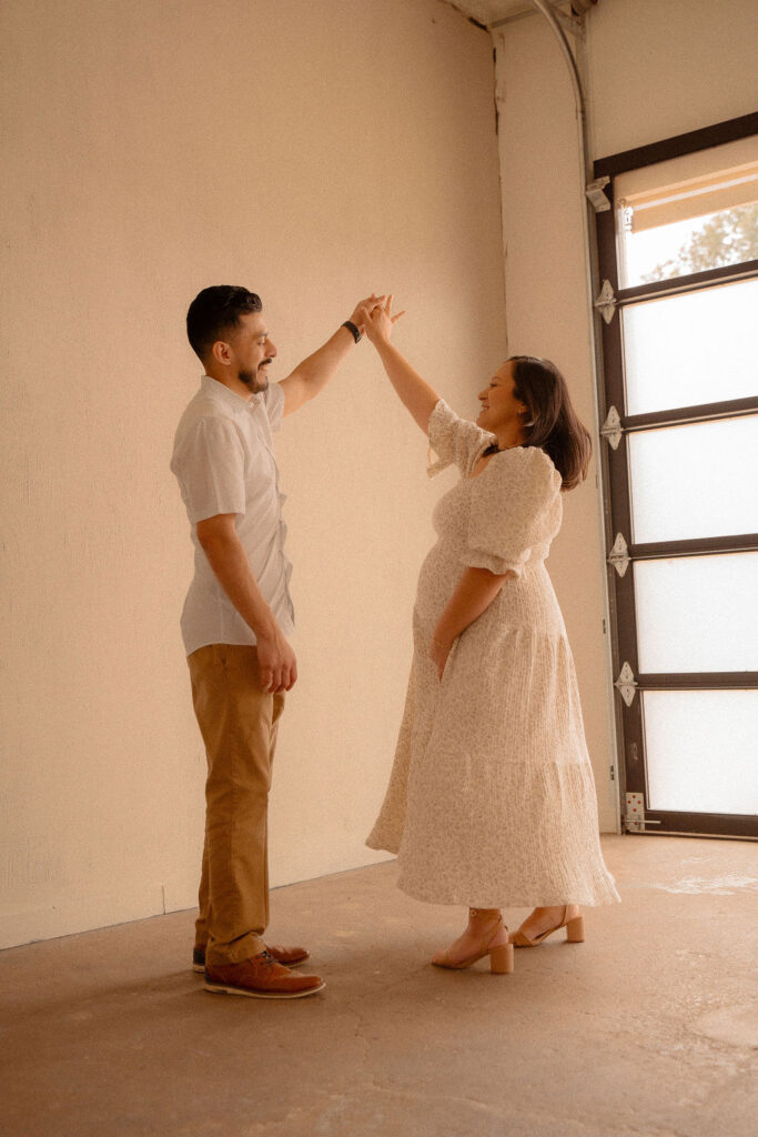Couple dancing at they maternity session 