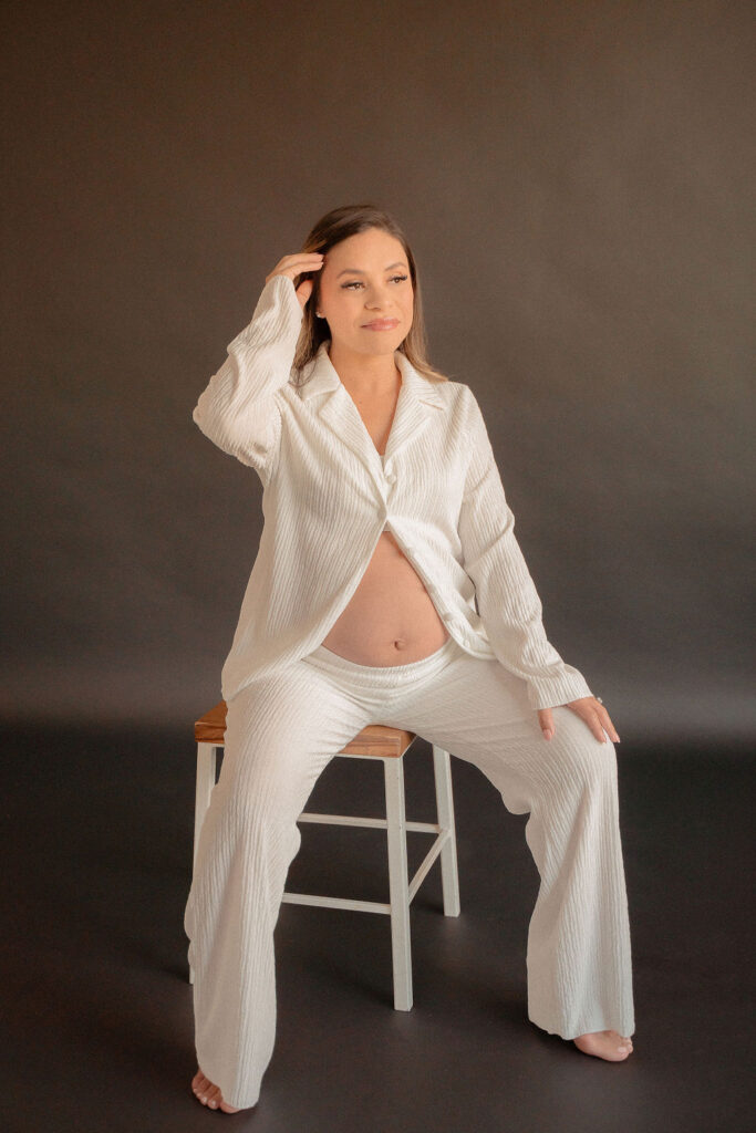 Fashionable maternity photoshoot with black backdrop