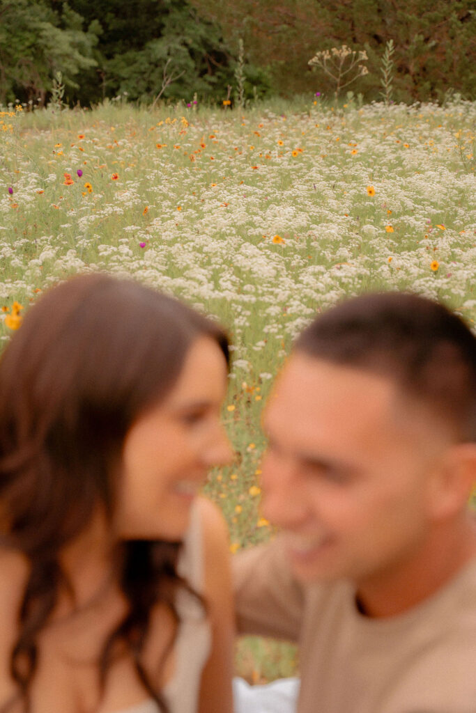 Blurred out couple with flowers in the background 